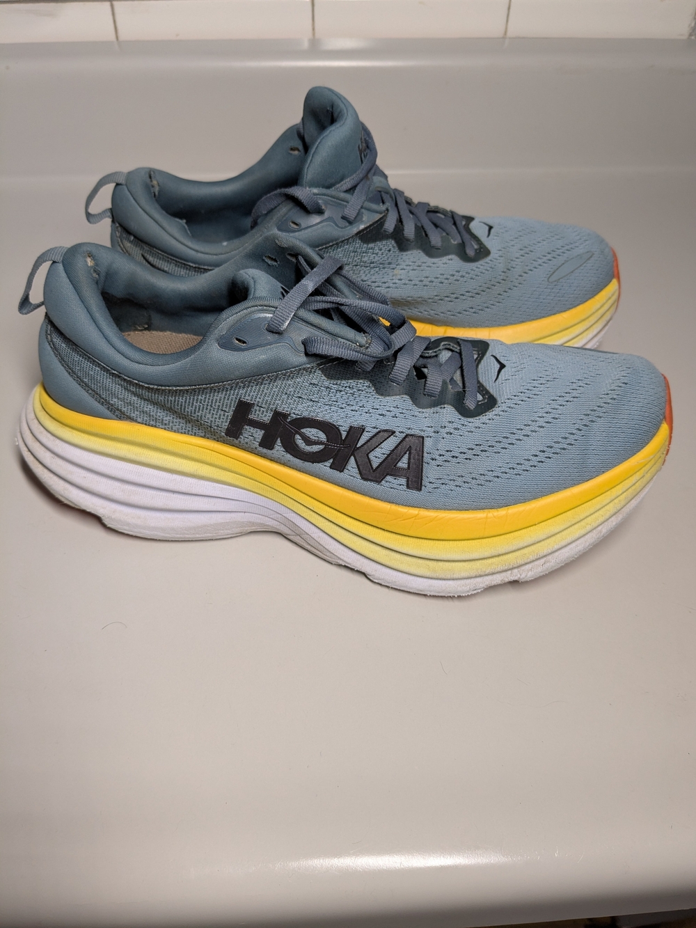 Hoka Bondi 8 Running Shoes And The Goblin Blue And Mountain Spring Colorway